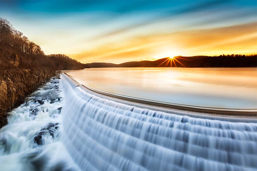 About Our Agency - Scenic View of the Croton Dam in Upstate New York During Sunrise with a Beautiful Colorful Sky